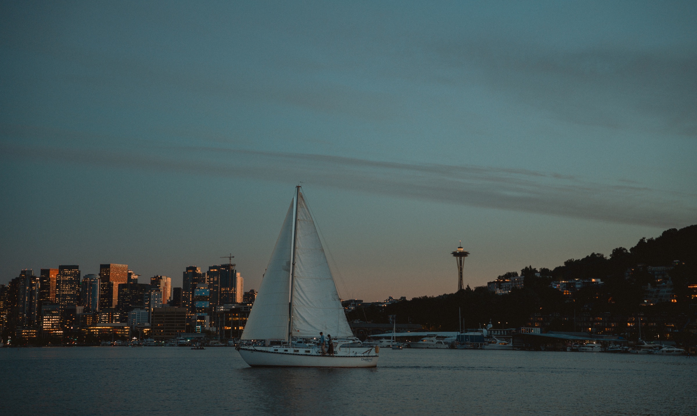 A sailboat on Lake Union at dusk